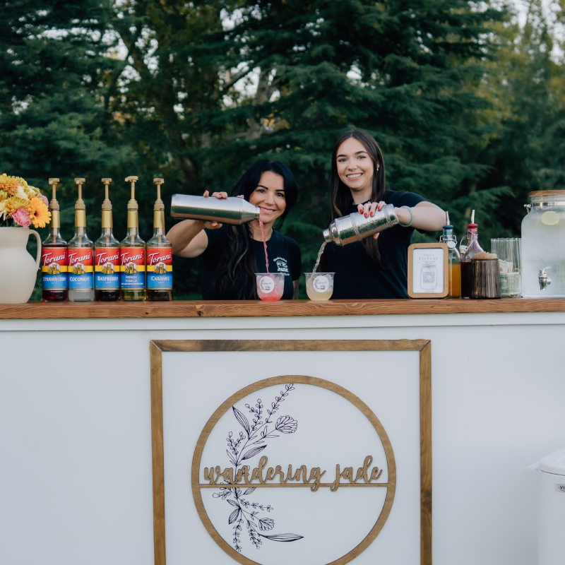 KateLynn and AmberDee pouring drinks behind the Gypsy Pop-up Bar