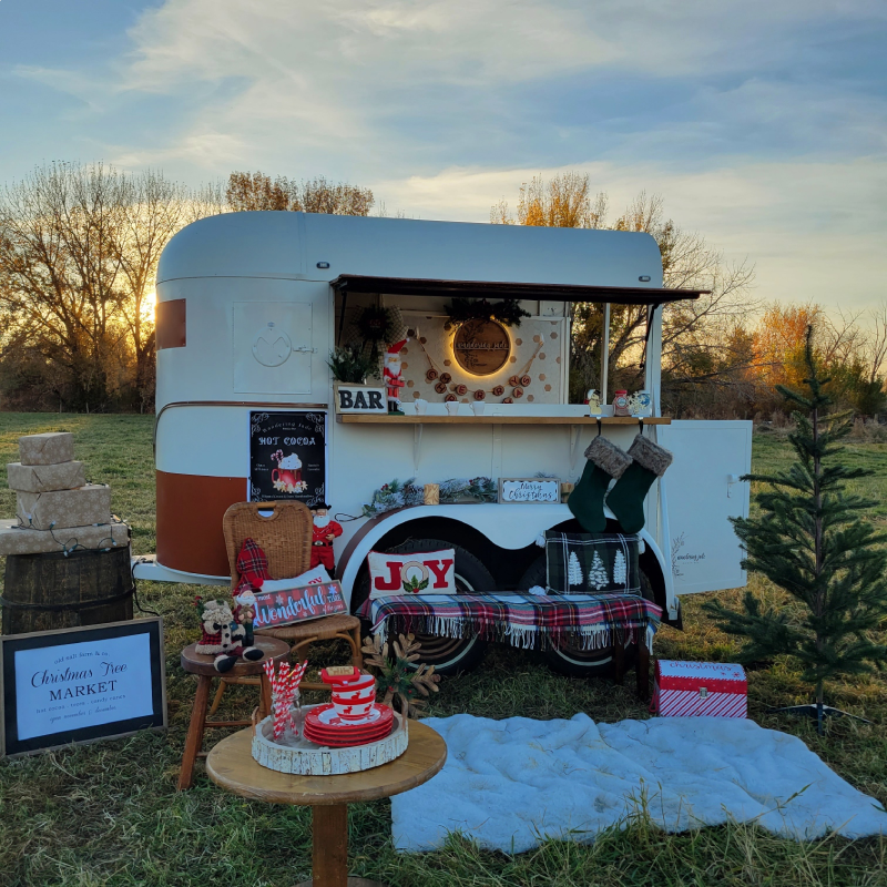 Photo of the Wandering Jade Trailer surrounded by Christmas Decorations.