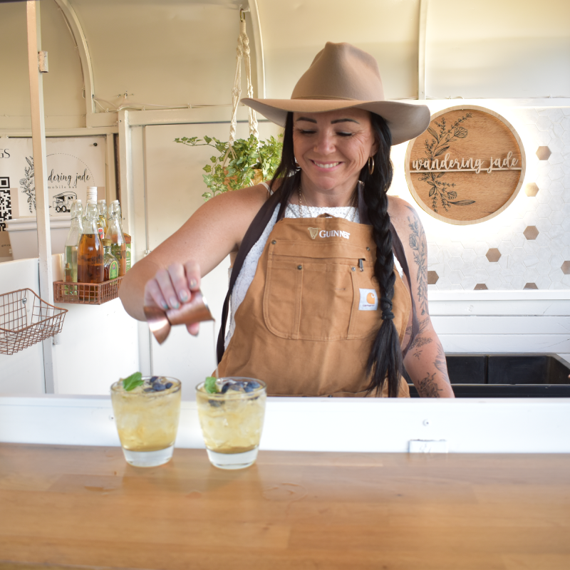 Photo of Amberdee (Owner) making drinks at the bar.