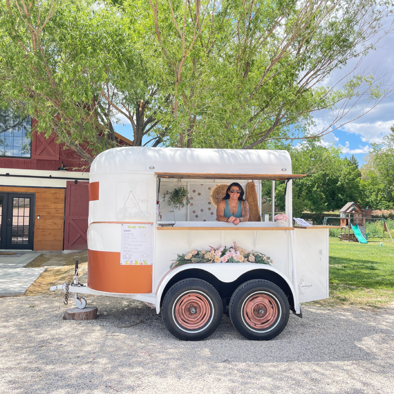 Photo of the Wandering Jade Trailer in front a barn.